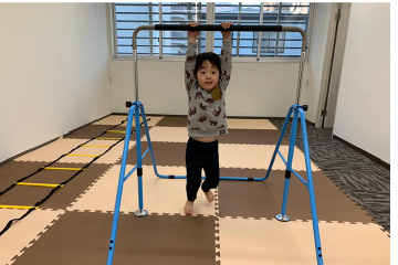 ぶら下がって遊ぶ子供